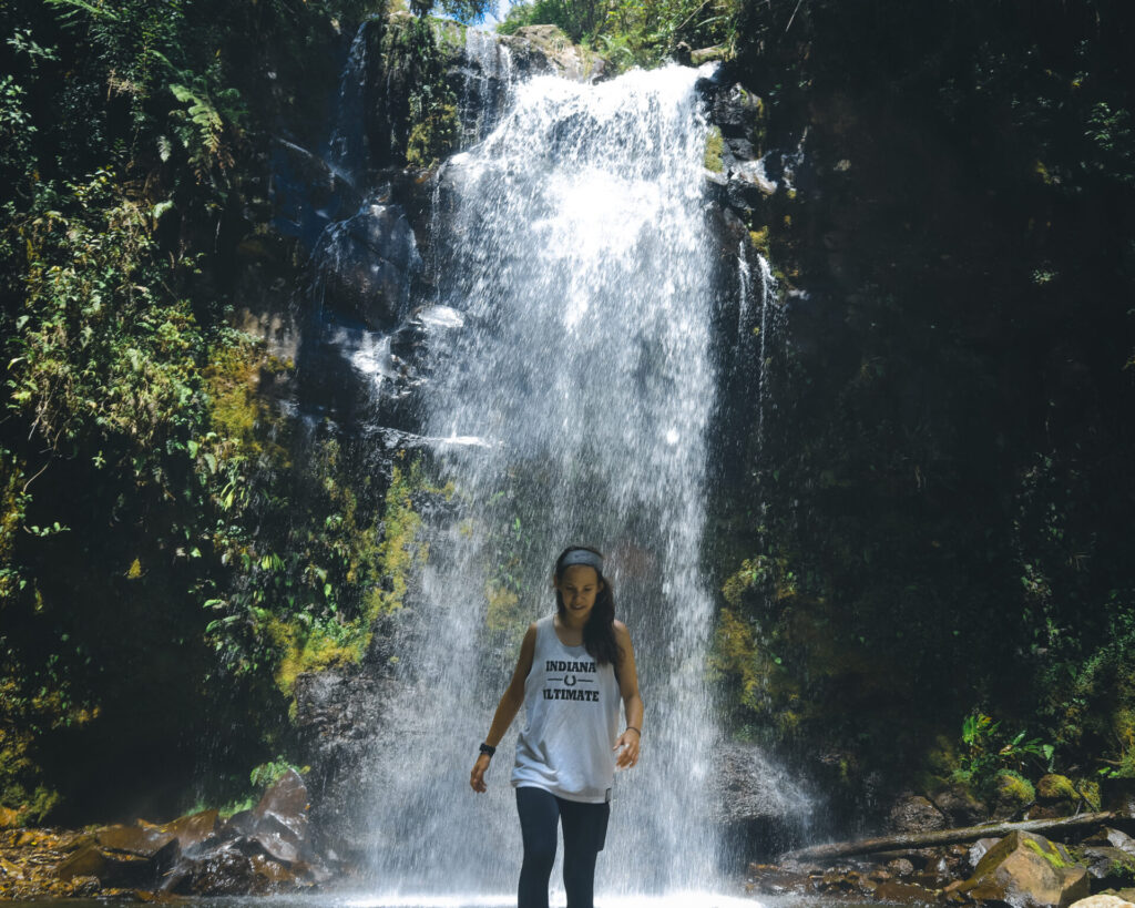 Wini under a waterfall on the Lost Waterfalls Trail in Boquete, Panama