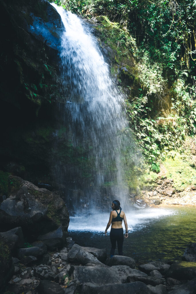 Wini under a waterfall on the Lost Waterfalls Trail in Boquete, Panama