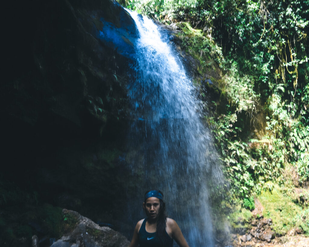 Wini under a waterfall on the Lost Waterfalls Trail in Boquete, Panama