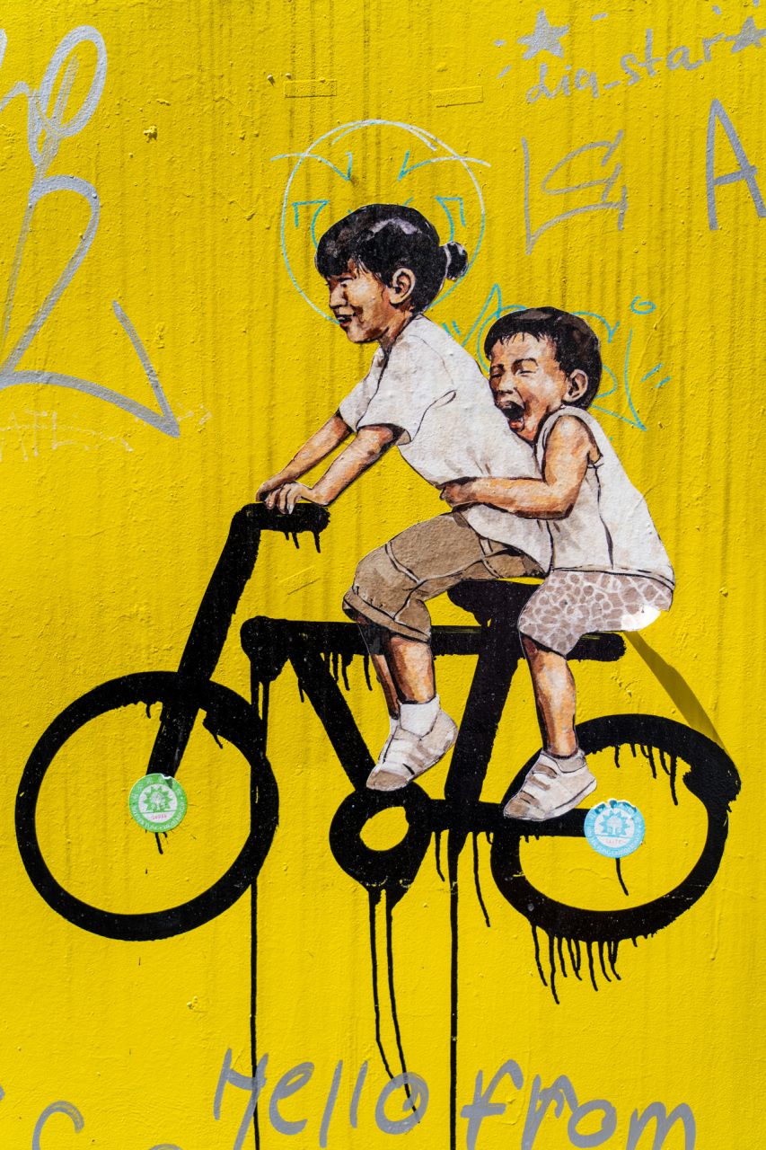 Children on Bicycle mural street art kids on a bike downtown Georgetown, Malaysia