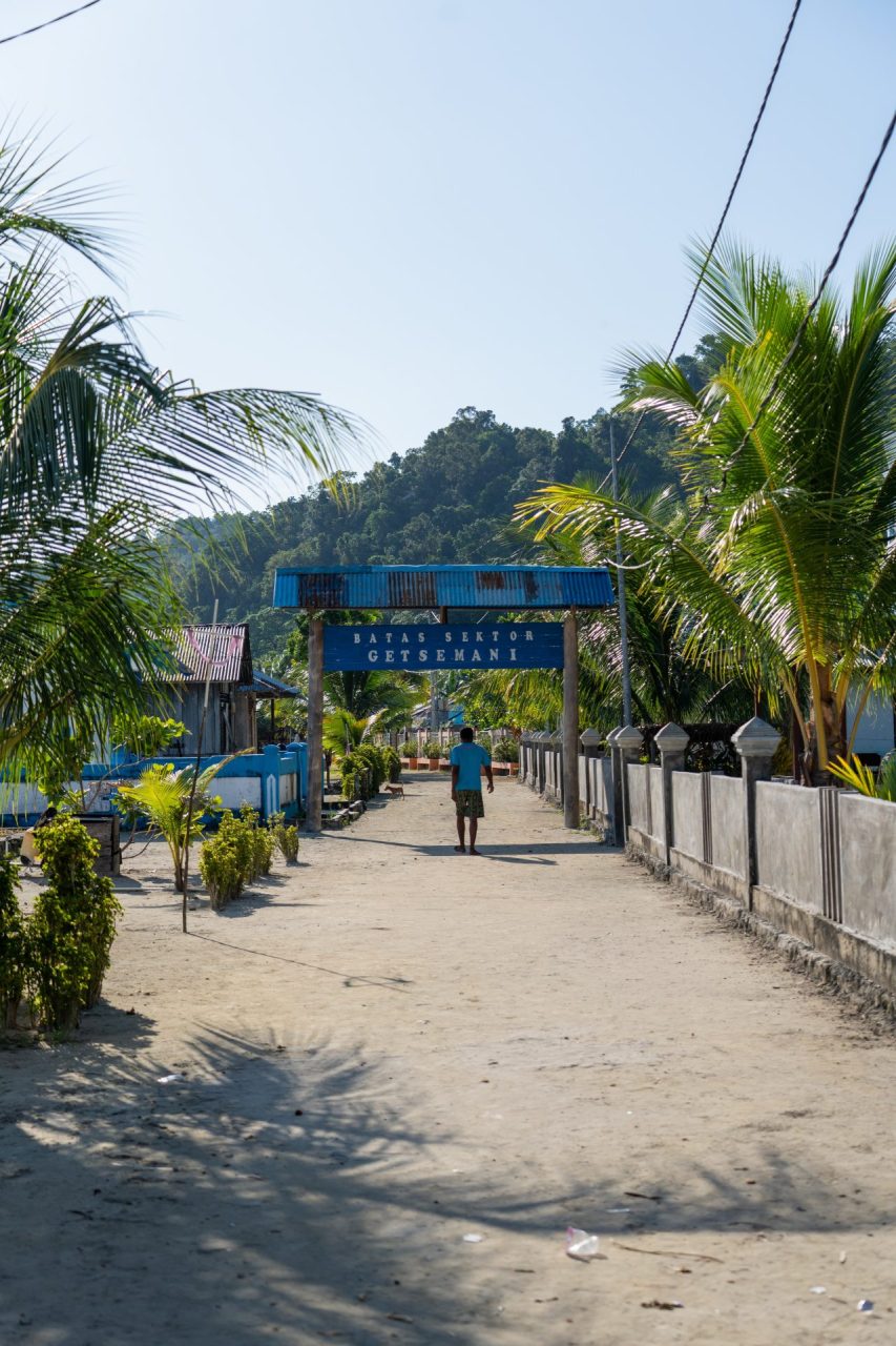 Fishing village with welcome sign, Raja Ampat, Indonesia