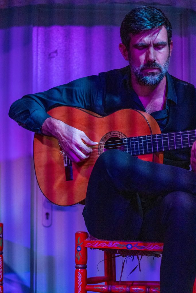 Flamenco guitarist (toque) playing at Casa de la Guitarra in Seville, Spain