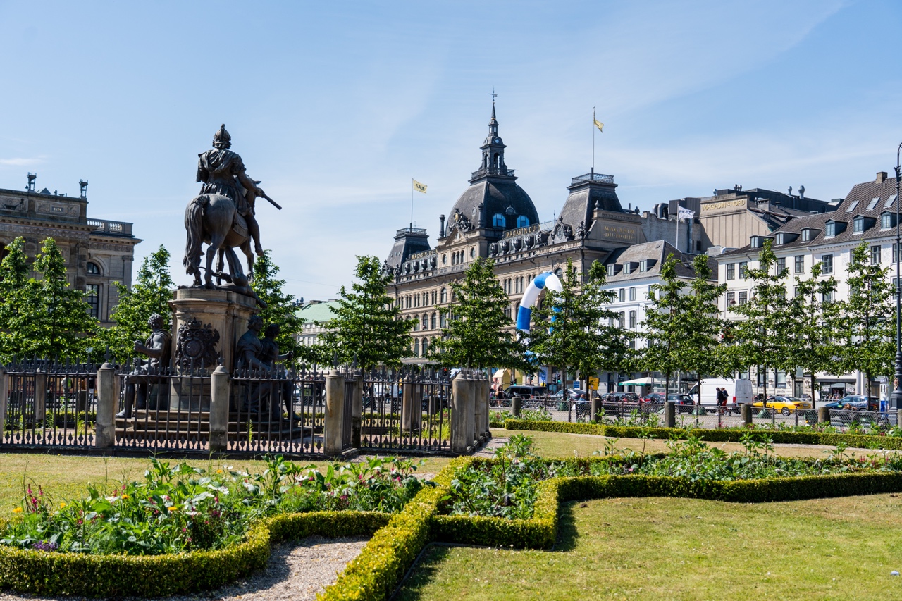 Kongens Nytorv Park with statue of King Christian V on horseback. Bright sunny day, Copenhagen, Denmark