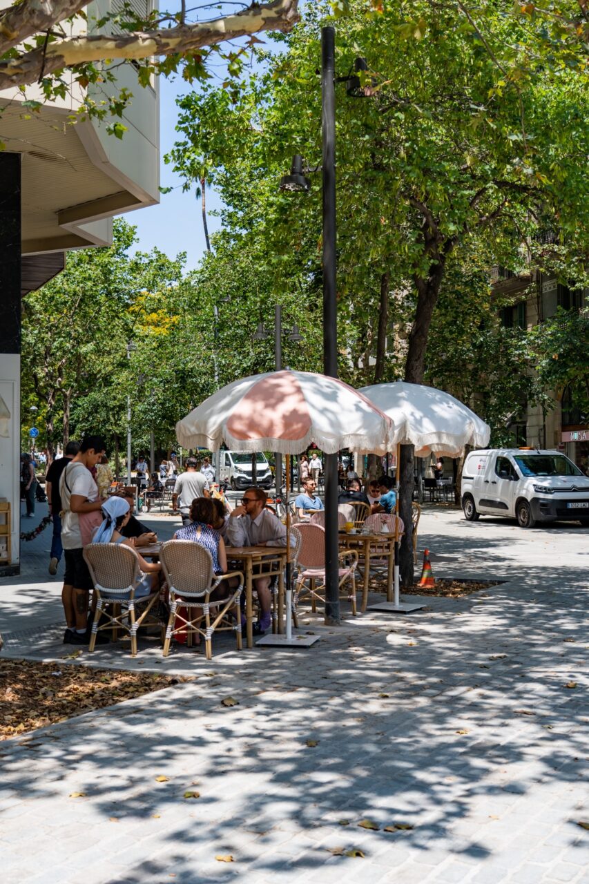 Outdoor restaurant in Barcelona, Spain with cute pink and white umbrellas