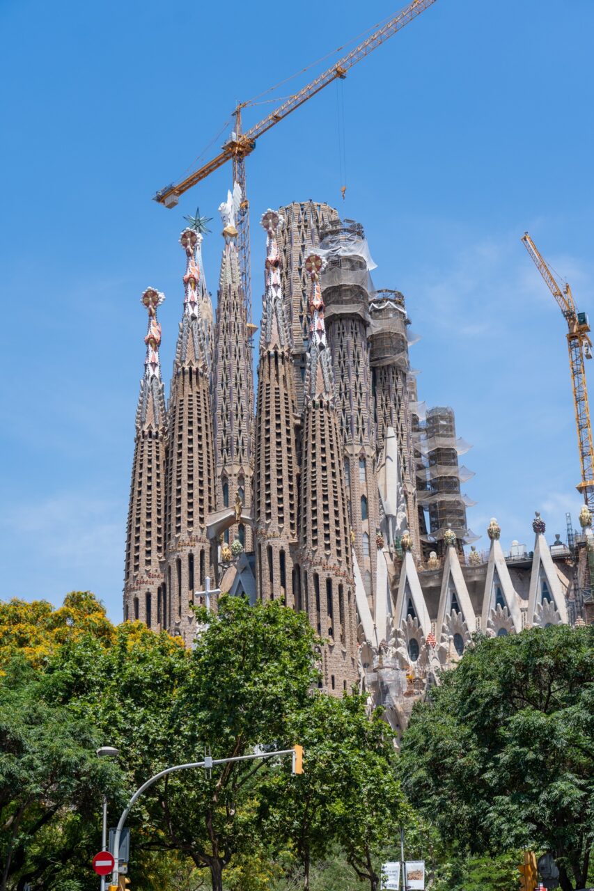 Sagrada Familia on a blue sky sunny day. Never ending construction happening above.