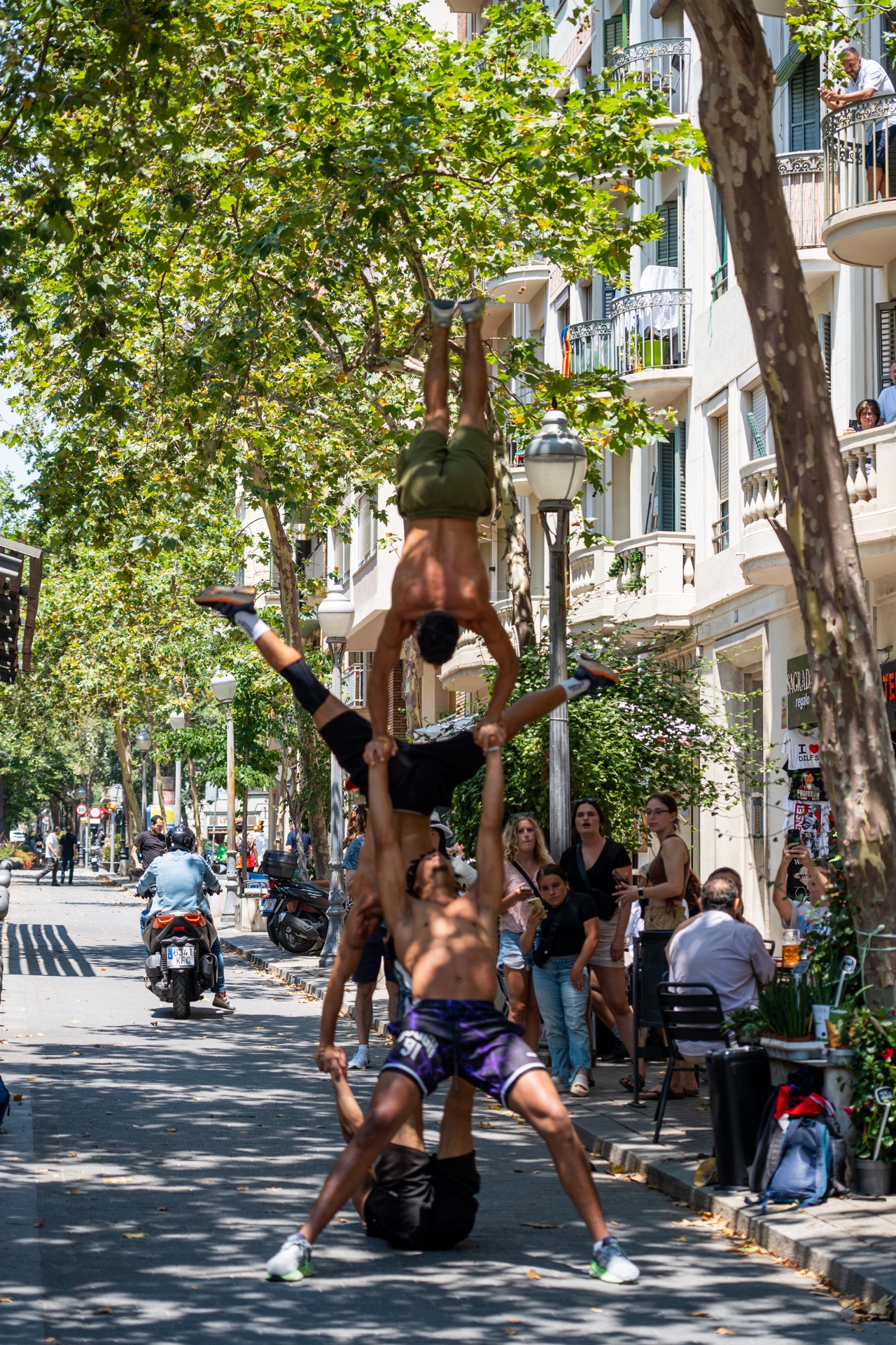 Male street dancers performing gravity defying tricks near Sagrada Familia in Barcelona, Spain