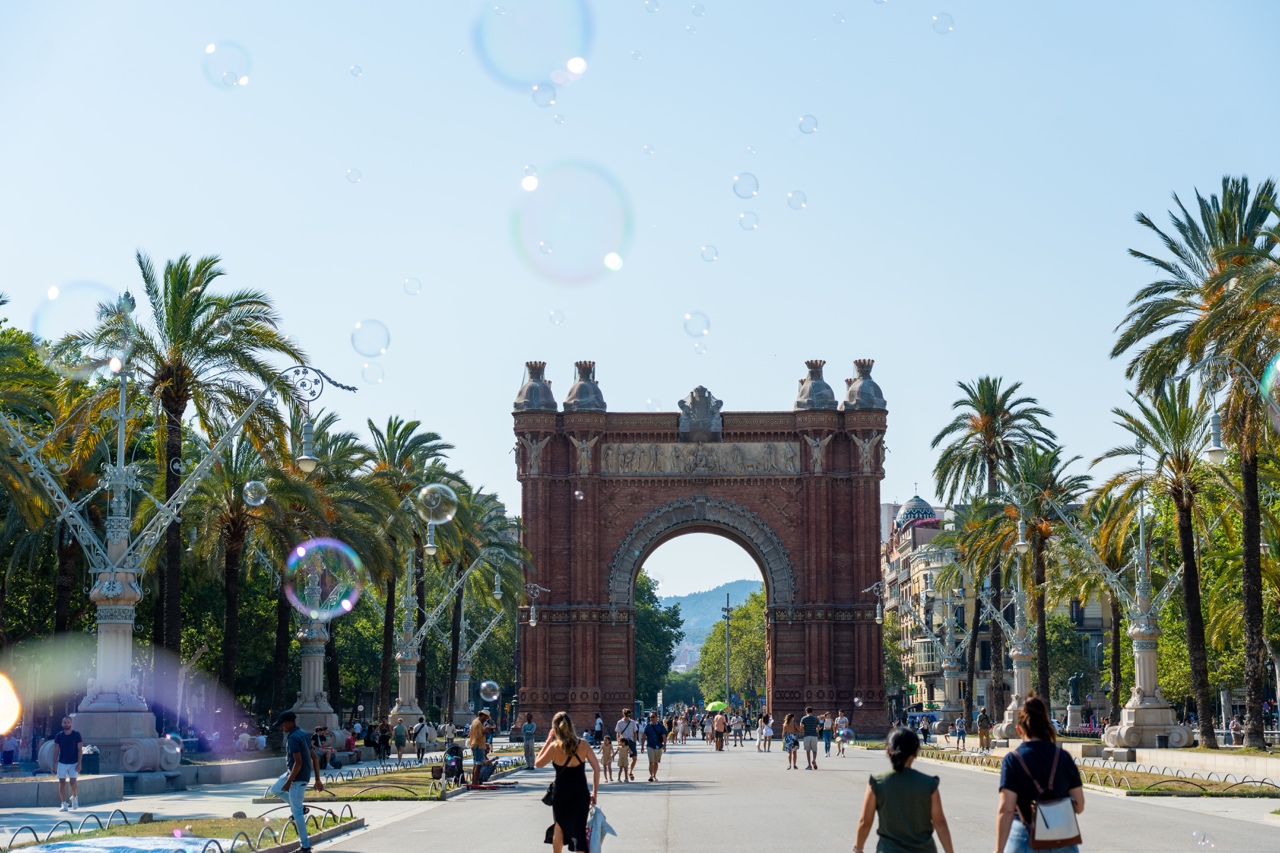 Arc de Triomf, Barcelona, Spain on a gorgeous summer day with bubbles blowing in front