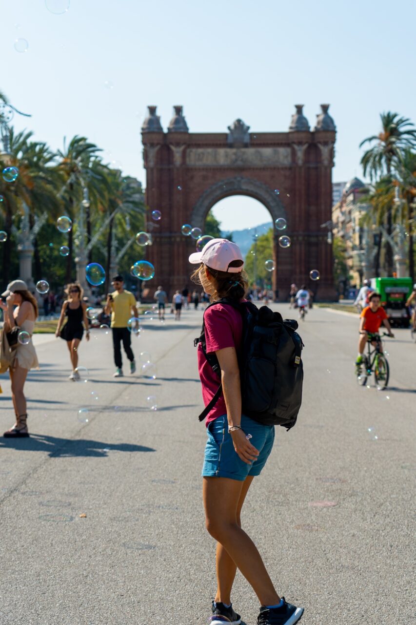 Bubbles and active people in front of Barcelona, Spain's Arc de Triomf