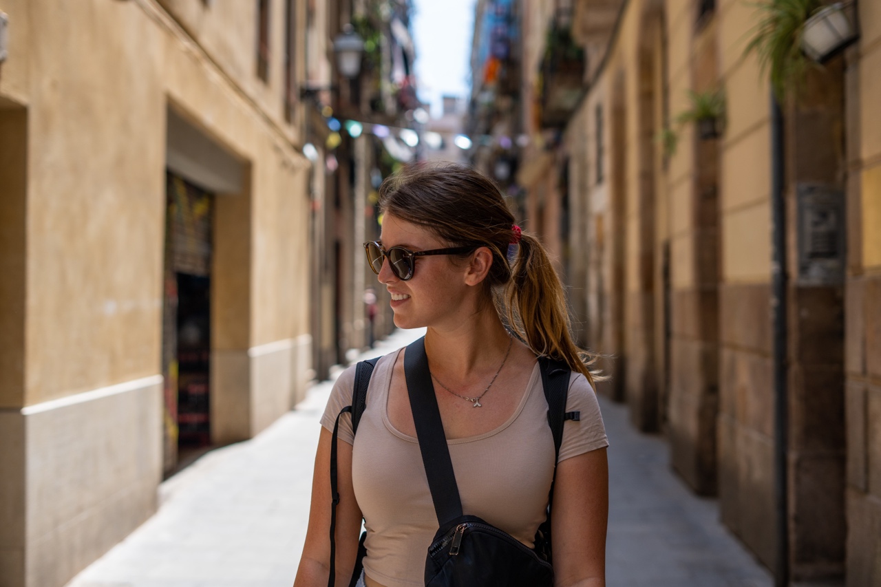 Woman walking down cute alleyway in Barcelona, Spain