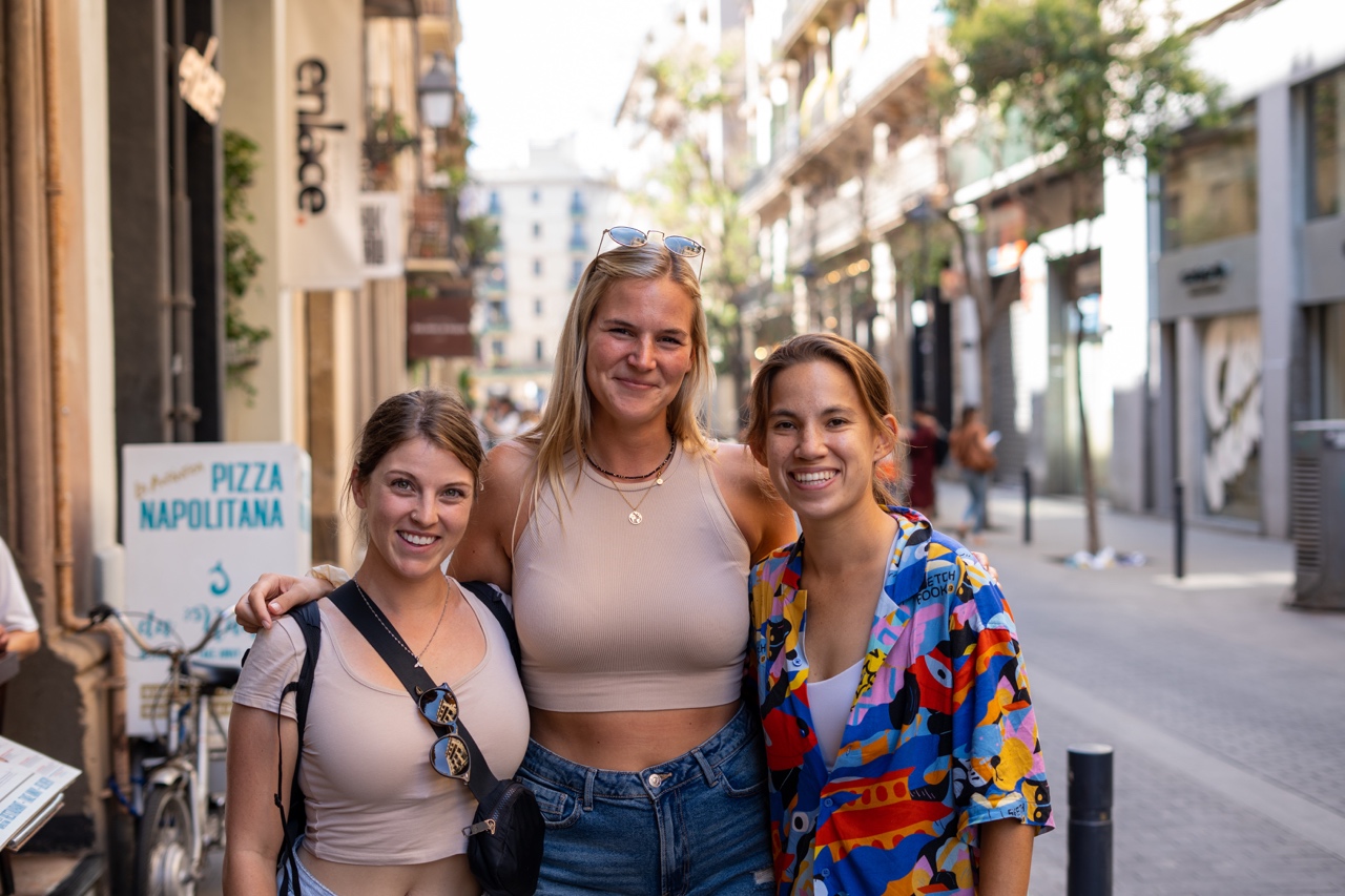 Three women in front of a delicious pizza place in Barcelona, Spain