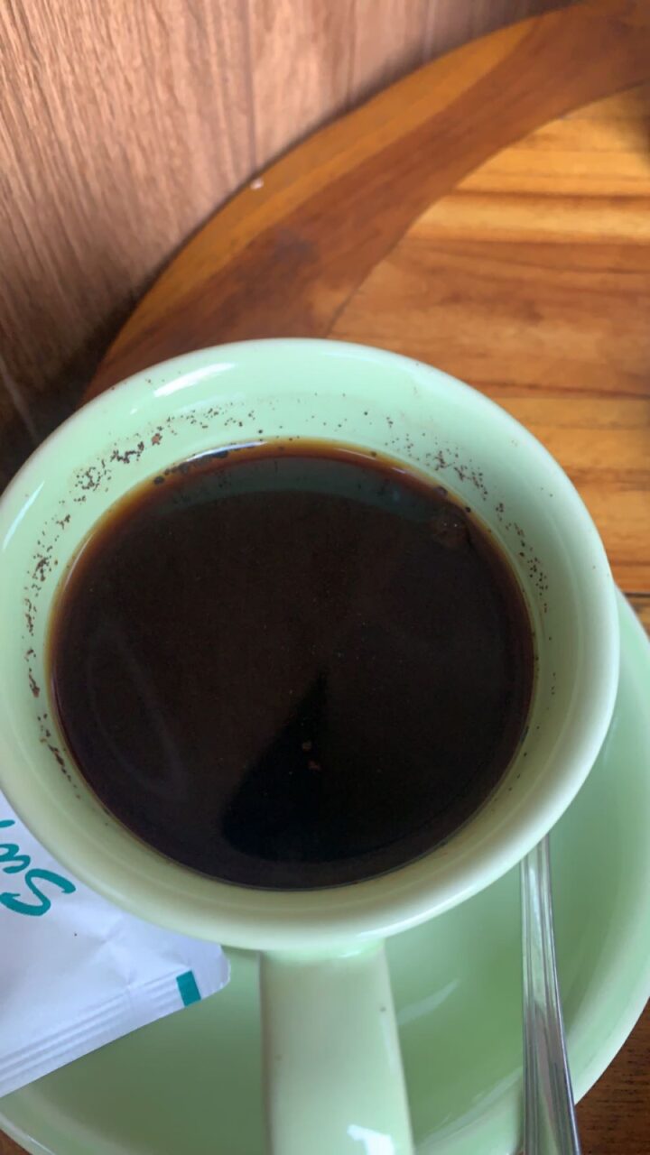 Balinese style coffee featuring undissolved coffee grounds.