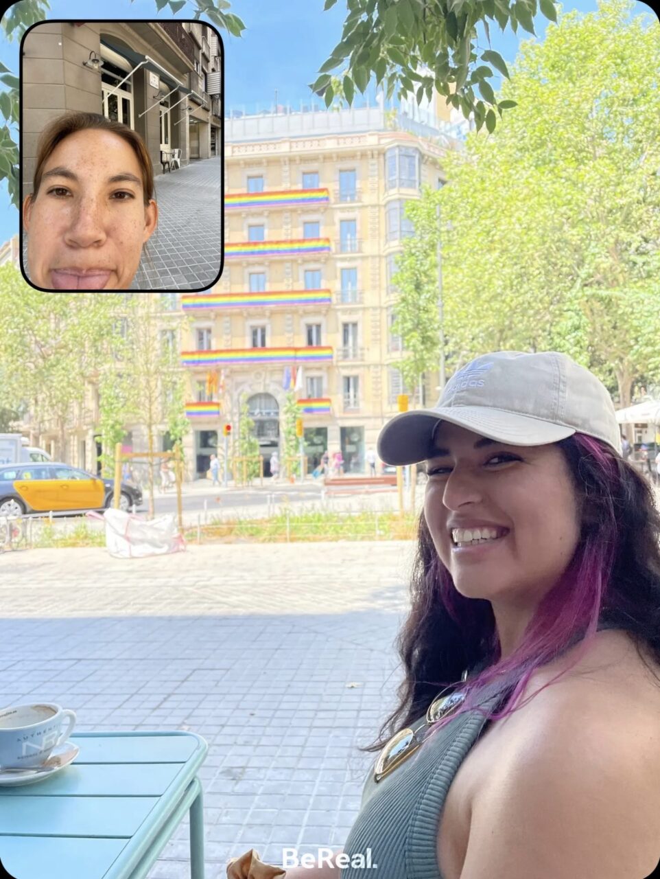 Wini and Sarah BeReal brunch while backpacking Barcelona, Spain. Building with rainbow pride flags prominently displayed in the background.
