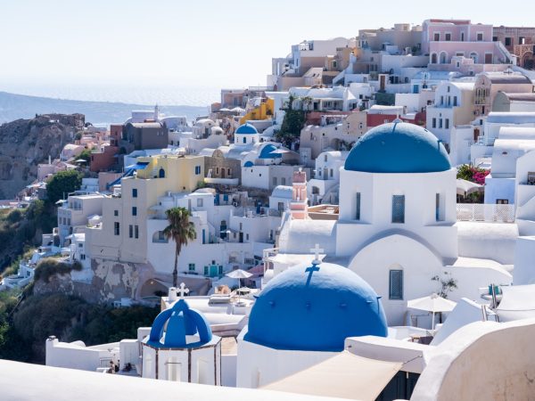 Santorini Fira to Oia hike, classic greek village, blue dome church roofs, aegean sea