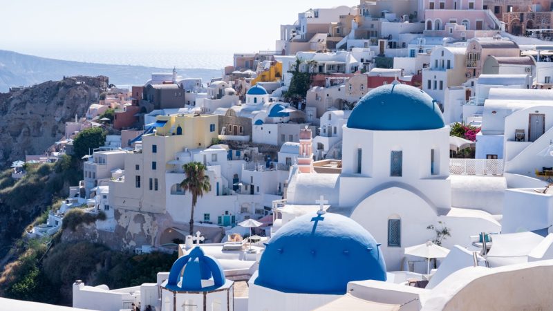 Santorini Fira to Oia hike, classic greek village, blue dome church roofs, aegean sea